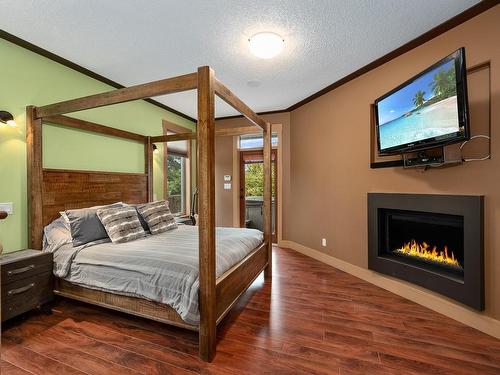 3872 Warren Ave, Royston, BC - Indoor Photo Showing Bedroom With Fireplace