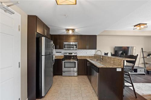 45 Kingsbury Square|Unit #402, Guelph, ON - Indoor Photo Showing Kitchen With Stainless Steel Kitchen With Double Sink
