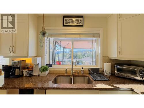 2258 Lillooet Crescent, Kelowna, BC - Indoor Photo Showing Kitchen With Fireplace With Double Sink
