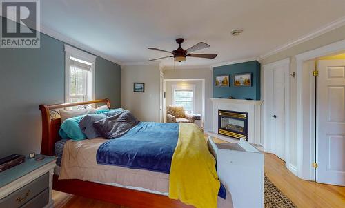 20 Kavanaghs Road, Clarkes Beach, NL - Indoor Photo Showing Bedroom With Fireplace