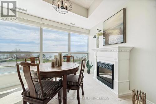 406 - 37 Ellen Street, Barrie (Lakeshore), ON - Indoor Photo Showing Dining Room With Fireplace