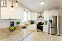 chef-inspired kitchen features granite countertops, high-end SS appliances, a breakfast bar, and a generous chef's pantry. - 