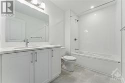 Main bathroom with upgraded tile and quartz counters - 