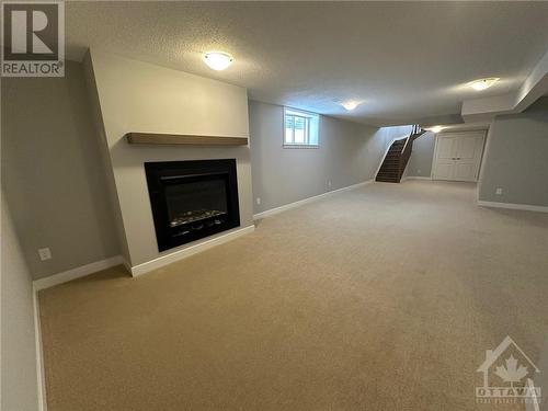 lower level (walkout) rec room - 608 Knotridge Street, Ottawa, ON - Indoor With Fireplace