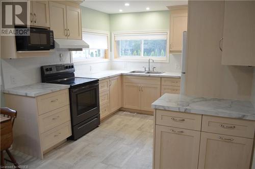 208 W Sweezy Street, Trout Creek, ON - Indoor Photo Showing Kitchen With Double Sink