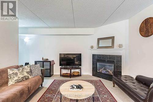 112 - 1471 Maple Avenue, Milton, ON - Indoor Photo Showing Living Room With Fireplace