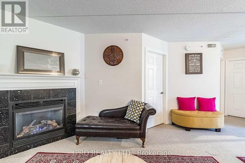 112 - 1471 Maple Avenue, Milton, ON - Indoor Photo Showing Living Room With Fireplace