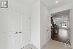 Foyer with ceramic floors and double door closet with swing doors - 