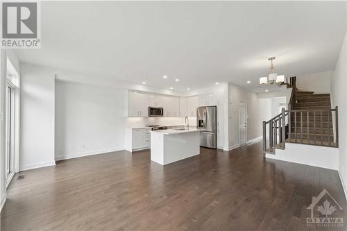 Hardwood floors that continue seemlessly into the kitchen - 316 Makobe Lane, Ottawa, ON - Indoor Photo Showing Kitchen