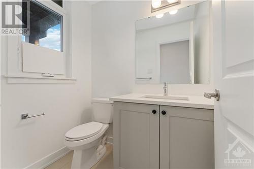 powder room with quartz counter and upgraded floor tile - 723 Odyssey Way, Ottawa, ON - Indoor Photo Showing Bathroom