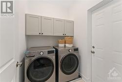 Main floor laundry with upper cabinets - 