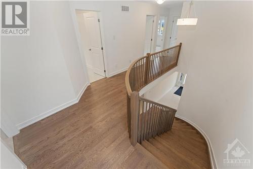 Curved hardwood staircase - 723 Odyssey Way, Ottawa, ON - Indoor Photo Showing Other Room