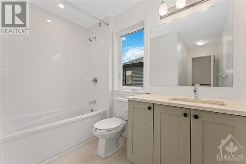 Main bathroom with quartz countertop and upgraded tile - 723 Odyssey Way, Ottawa, ON - Indoor Photo Showing Bathroom