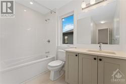 Main bathroom with quartz countertop and upgraded tile - 