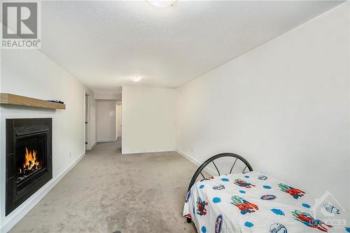 Basement - 1028 Hydrangea Avenue, Ottawa, ON - Indoor Photo Showing Bedroom With Fireplace