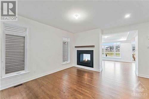 Living room with double sided gas fireplace - 705 Rosales Ridge, Ottawa, ON - Indoor Photo Showing Living Room With Fireplace