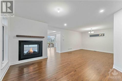 living dining area with beautiful hard wood flooring - 705 Rosales Ridge, Ottawa, ON - Indoor Photo Showing Other Room With Fireplace