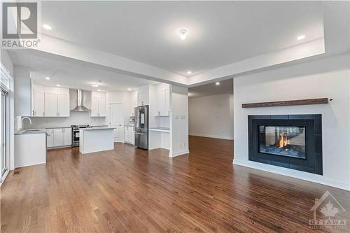 Family room with double sided gas fireplace - 705 Rosales Ridge, Ottawa, ON - Indoor With Fireplace