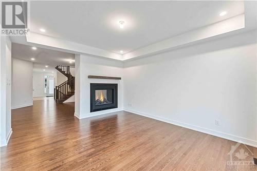 Main floor view from patio door - 705 Rosales Ridge, Ottawa, ON - Indoor Photo Showing Living Room With Fireplace