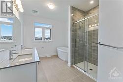 Luxury ensuite with double sink vanity, quartz counters, stand  alone tub, glass/ceramic shower and upgraded tile - 