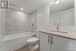 Basement bathroom with quartz counters and upgraded tile - 