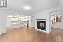 Great room with double sided fireplace and gleaming hardwood floors - 