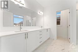 Primary ensuite with double sink vanity, quartz counters and upgraded tile & private water closet - 
