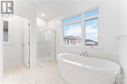 Primary ensuite, stand alone tub and ceramic/glass shower - 