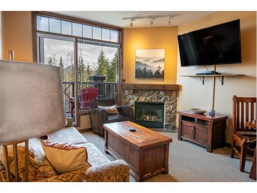 105 - 1549 Kicking Horse Trail, Golden, BC - Indoor Photo Showing Living Room With Fireplace
