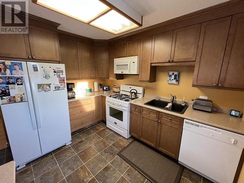 5504 Churchill Avenue, Fort Nelson, BC - Indoor Photo Showing Kitchen With Double Sink