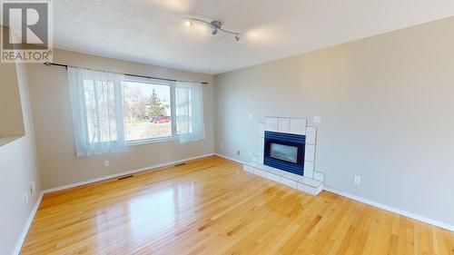 9715 91 Street, Fort St. John, BC - Indoor Photo Showing Living Room With Fireplace