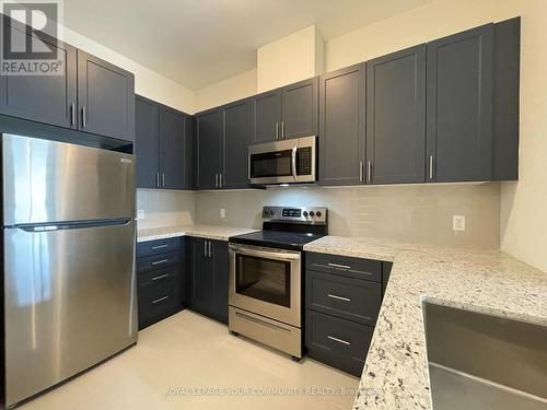 #803 -5917 Main St, Whitchurch-Stouffville, ON - Indoor Photo Showing Kitchen With Stainless Steel Kitchen