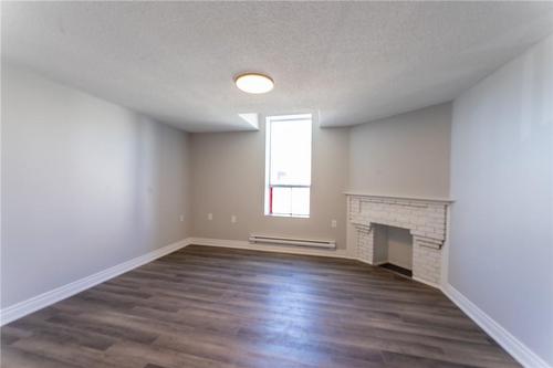 69 East Main Street|Unit #204, Welland, ON - Indoor Photo Showing Other Room With Fireplace