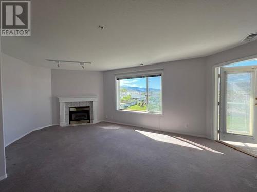 6805 Cottonwood Drive Unit# 210, Osoyoos, BC - Indoor Photo Showing Living Room With Fireplace