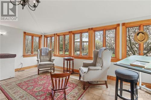 Sit in the sunny bright sunroom and enjoy the nature around you - 7080 Devereaux Road, Ottawa, ON - Indoor