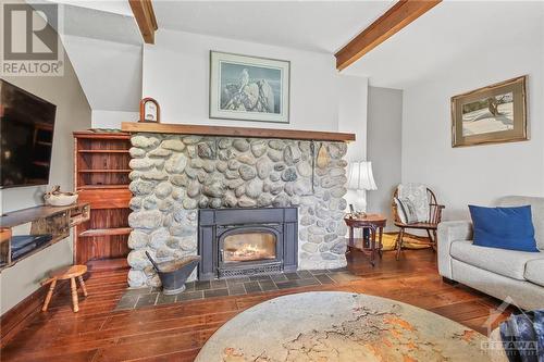 Cosy livingroom with woodburning fireplace insert (2017) - 7080 Devereaux Road, Ottawa, ON 
