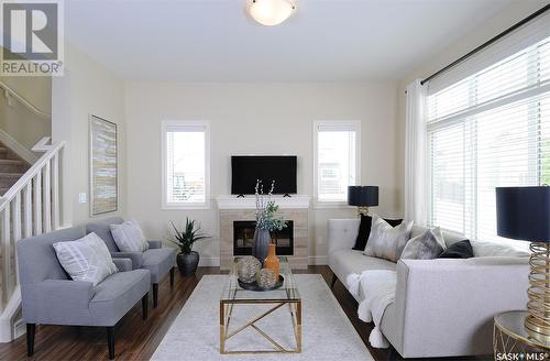 222 Schmeiser Bend, Saskatoon, SK - Indoor Photo Showing Living Room With Fireplace
