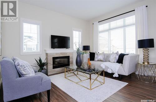 222 Schmeiser Bend, Saskatoon, SK - Indoor Photo Showing Living Room With Fireplace