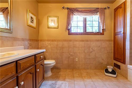 Large in size, the main bath was built to be shared amongst multiple children. Additional storage spaces hold linens, towels, and toiletries keeping them out of sight. - 23 Winona Park Road, Stoney Creek, ON - Indoor Photo Showing Bathroom