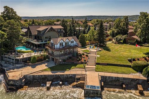 The shoreline is protected from erosion while the home sits safely on high ground and set back from neighbouring homes to create additional privacy. - 23 Winona Park Road, Stoney Creek, ON - Outdoor With View