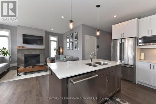 50 - 555 Sunningdale Road E, London, ON - Indoor Photo Showing Kitchen With Fireplace With Stainless Steel Kitchen With Double Sink With Upgraded Kitchen
