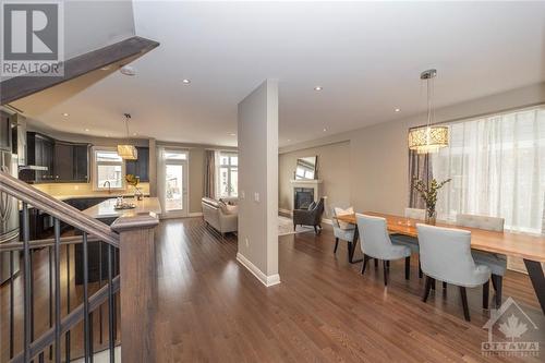 Elegant open-concept living, with hardwood flooring, smooth ceilings, strategic pot lights, and upgraded lighting fixtures makes for a seamless blend of comfort and function. - 268 Huntsville Drive, Ottawa, ON - Indoor Photo Showing Dining Room
