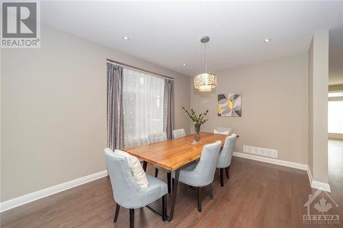 The dining area with upgraded lighting fixture is a spacious gathering space! - 268 Huntsville Drive, Ottawa, ON - Indoor Photo Showing Dining Room