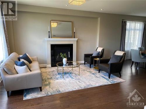 Enjoy relaxing with loved ones in the living room with gas fireplace and large windows - 268 Huntsville Drive, Ottawa, ON - Indoor Photo Showing Living Room With Fireplace