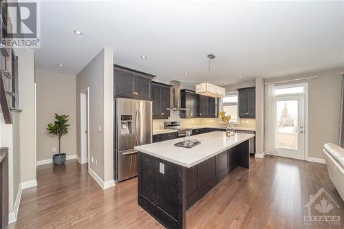 Updated quartz counters, stainless steel appliances, and plenty of cabinetry make this kitchen a chef's delight! Imagine entertaining from behind the island while guests look on! - 268 Huntsville Drive, Ottawa, ON - Indoor Photo Showing Kitchen With Upgraded Kitchen