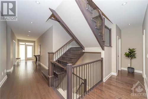 Hardwood stairs with iron spindles add a graceful touch - 268 Huntsville Drive, Ottawa, ON - Indoor Photo Showing Other Room