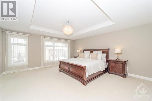 A primary bedroom fit for royalty! The generously-sized room is not lacking in space. Two walk-in closets lead the way to the ensuite. - 268 Huntsville Drive, Ottawa, ON - Indoor Photo Showing Bedroom