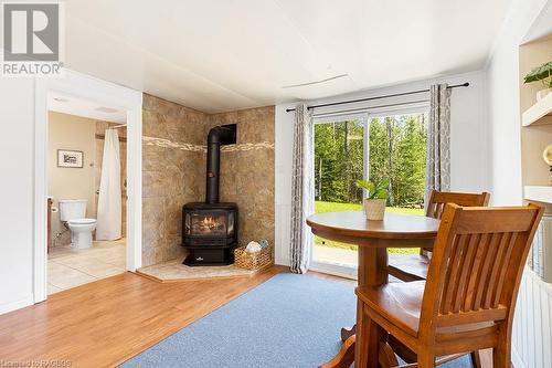 Cozy gas fireplace and lots of natural light from the patio doors - 710 West Road, Northern Bruce Peninsula, ON - Indoor With Fireplace