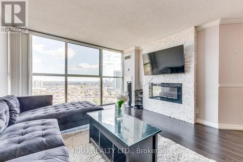 2111 - 35 Trailwood Drive E, Mississauga, ON - Indoor Photo Showing Living Room With Fireplace