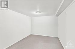 Den/Entertainment/Storage Room in Basement.  Virtually Decluttered. - 